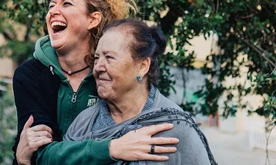 Voluntària abraçant una dona gran