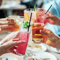 Un grup d'amigues brindant amb begudes alcohòliques refrescants.