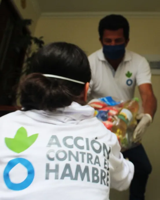 Voluntaris d'Acció contra la Fam transportant aliments