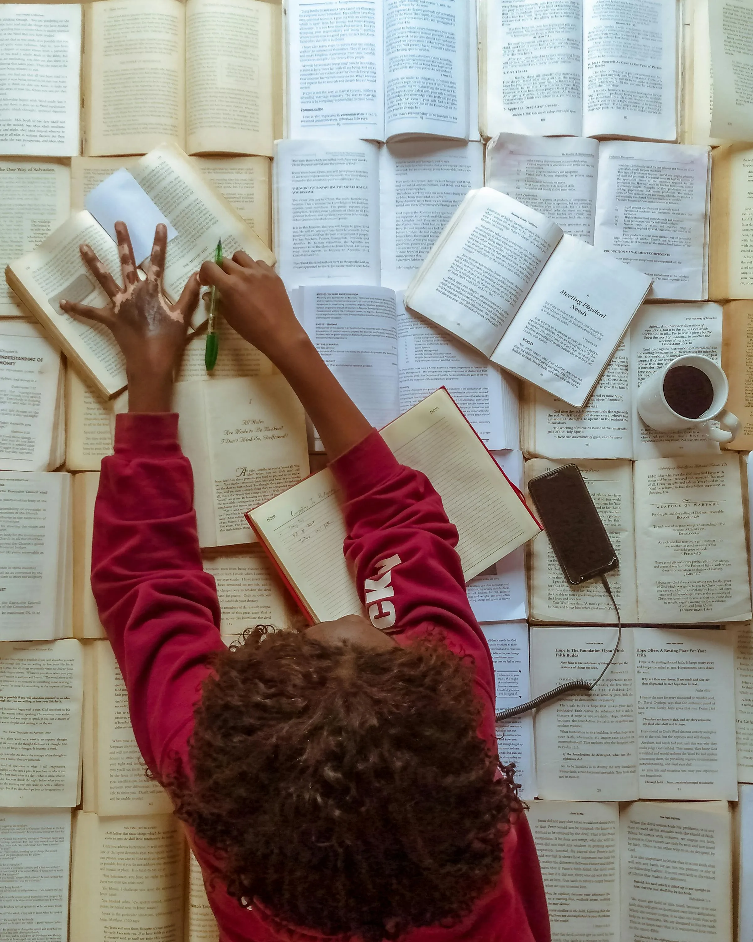 Persona llegint molts llibres. Font: Pexels - Adegbenro Emmanuel Persona llegint molts llibres. Font: Pexels - Adegbenro Emmanuel