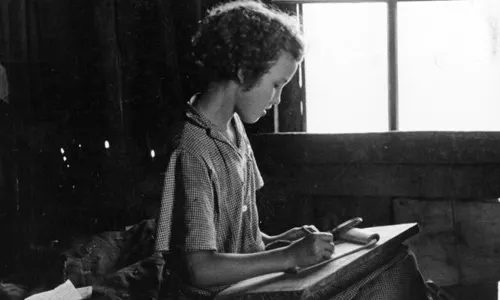 Nena escribint al 1937. Font: Galeria del Kheel Center