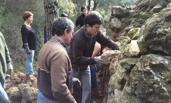 Amb les jornades de voluntariat es restaura el patrimoni mentres es pot aprendre la tècnica de la construcció en pedra seca (imatge:riugaia.cat)