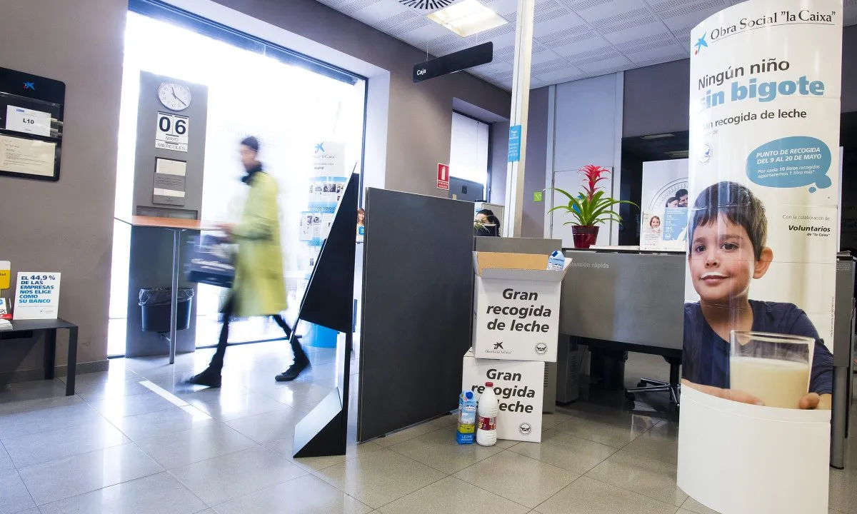 Imatge d'una oficina de la Caixa amb un punt de recollida de llet per la campanya