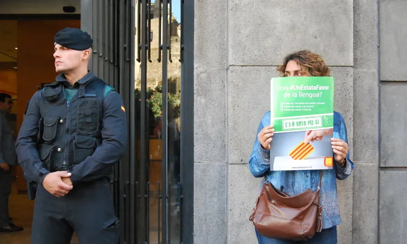 Una dona es manifesta al costat d'un agent de la Guàrdia Civil