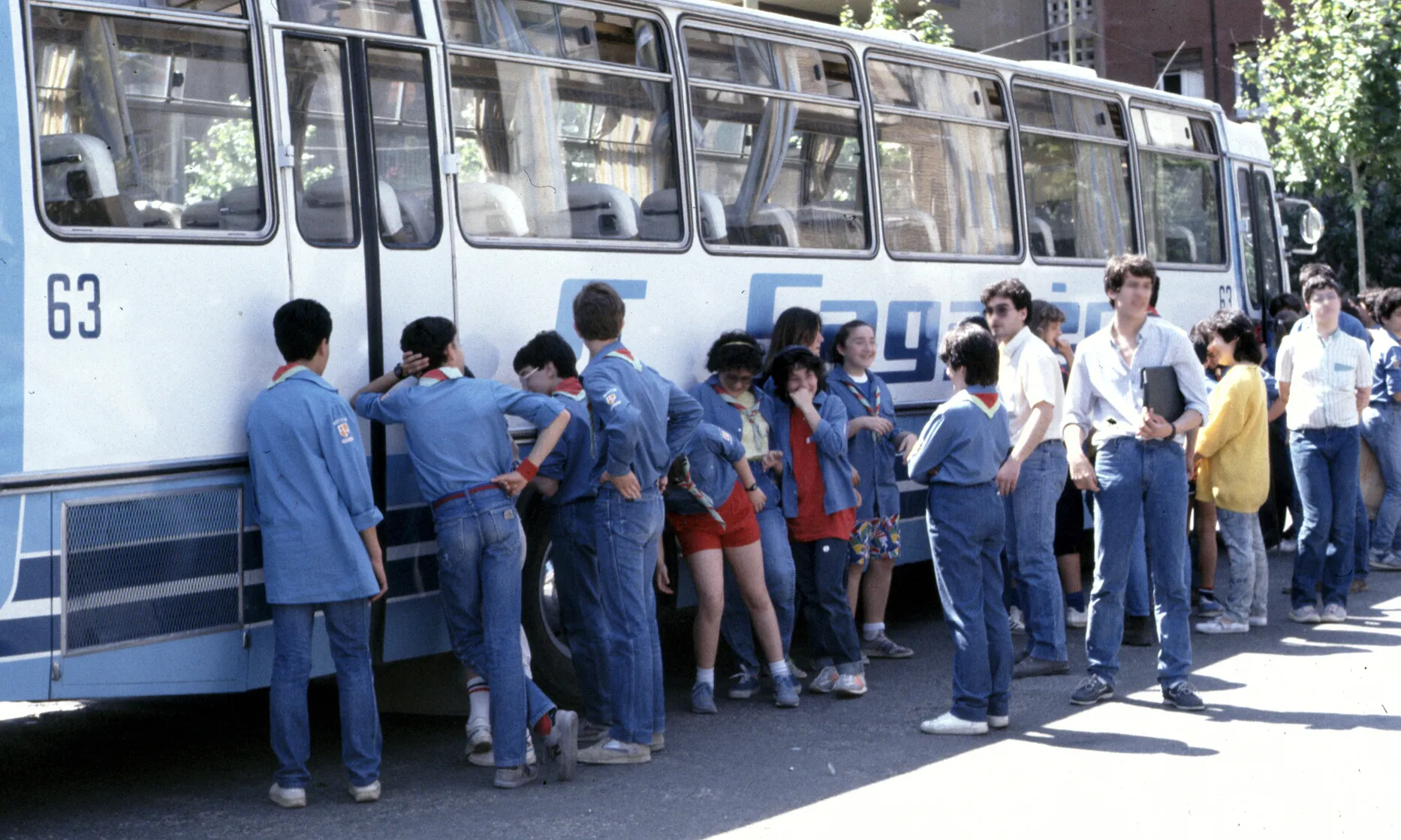 Joves escoltes esperant per pujar a l'autocar per marxar de campaments