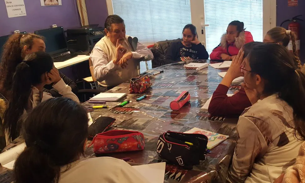 Un grup de noies atenen l'explicació en una classe de llengua caló