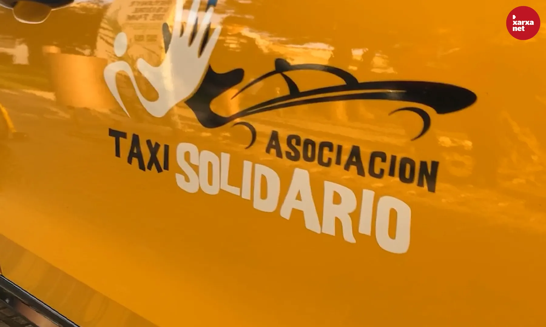 El logo de l'Associació Taxi Solidari, visible als cotxes dels 35 taxistes que en són membres. 