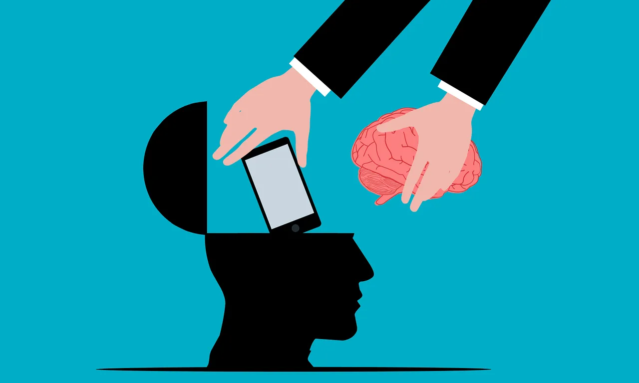 Il·lustració d'una mà que posa un mòbil dins d'un cervel que il·lustra les imposicions que los noves tecnologies suposen sovint per a les persones.