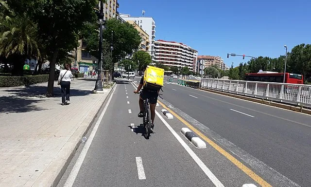 Una persona treballadora de Glovo en bicicleta a València.
