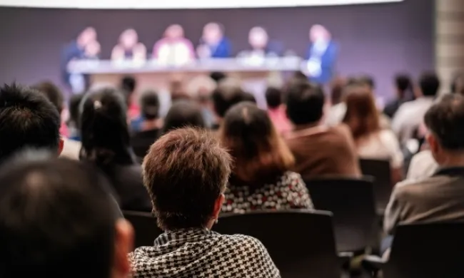 Persones seguint una conferència en representació de la jornada 'L'agenda europea de les competències per un mercat laboral dinàmic i inclusiu'. Font: Adobe Stocks