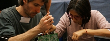 Un voluntari reparador ajuda a una usuària a reparar un ordinador Font: Restarters Barcelona