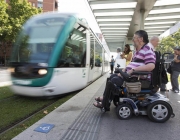 Una persona amb cadira de rodes esperant el tramvia per desplaçar-se. Font: ECOM