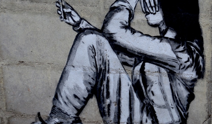 Un graffiti en que apareix una persona jove amb el seu telèfon mòbil. Font: Pixabay
