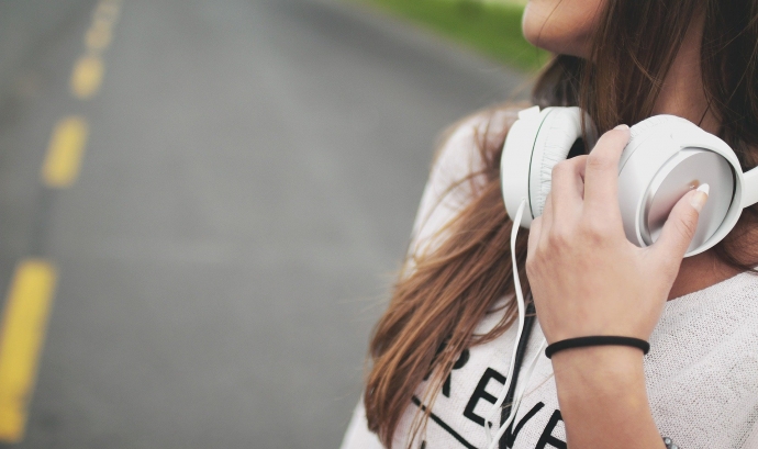Una noia escolta música mentre camina per una carretera. Font: Foundry Co (Pixabay)