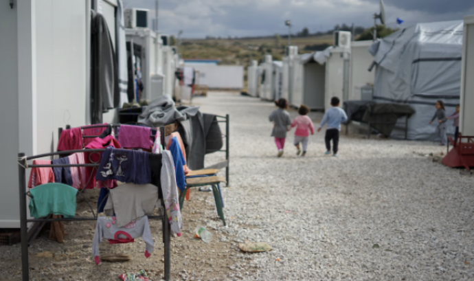 Imatge de tres infants jugant al camp de persones refugiades on viuen per representar la conferència. Font: Llicència CC Unsplash