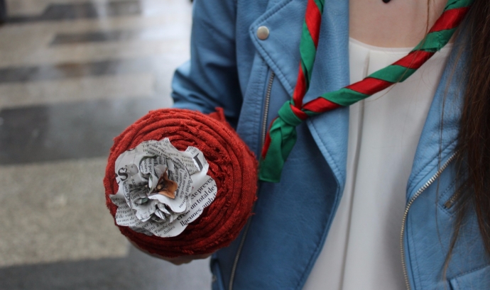 Una noia amb fulard sosté una rosa Font: Minyons Escoltes i Guies de Catalunya